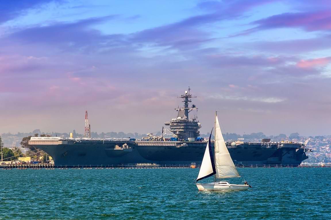 Aircraft carrier and a sailboat on the San Diego Bay